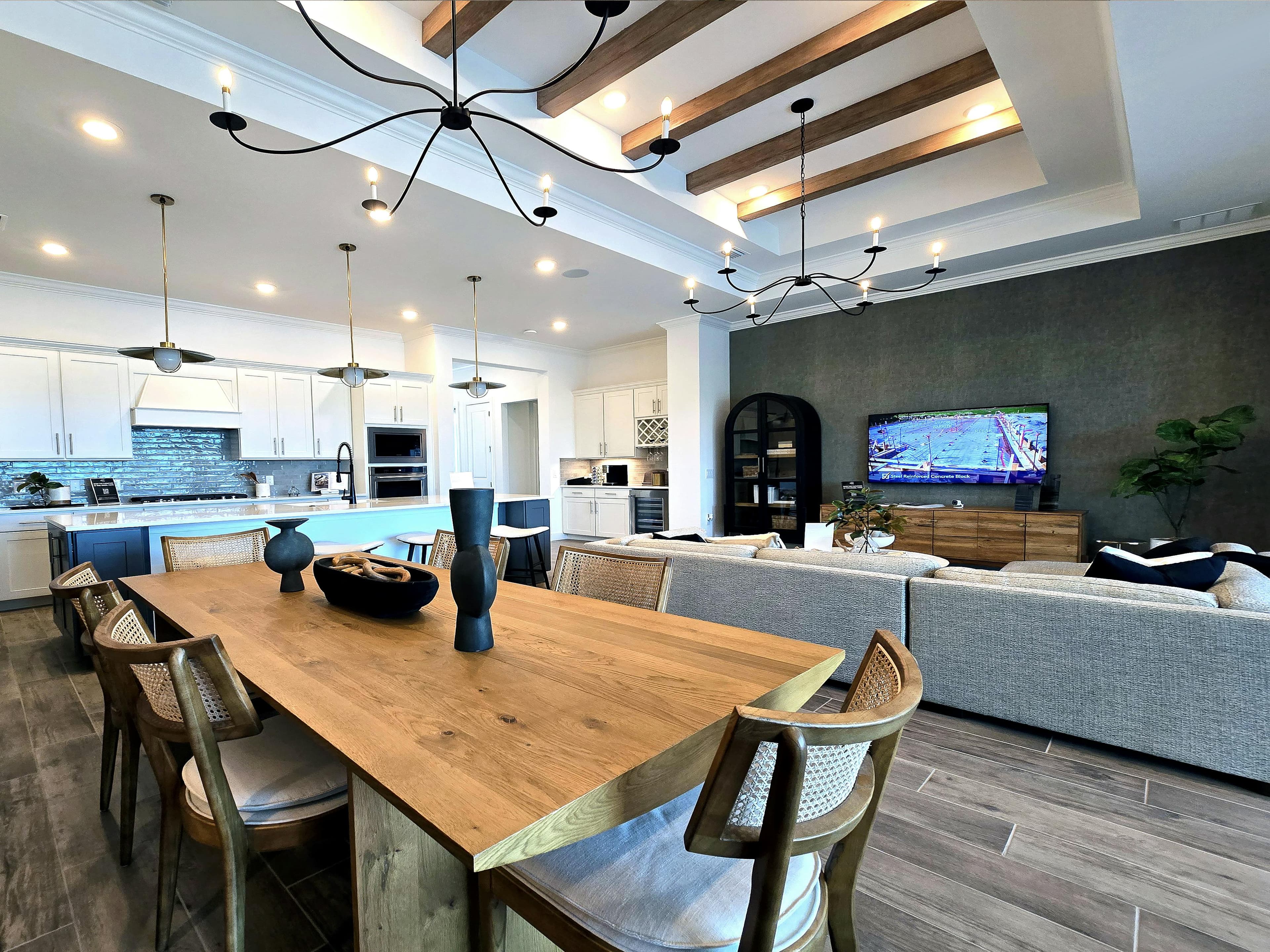 Modern dining and living space with exposed beam ceiling