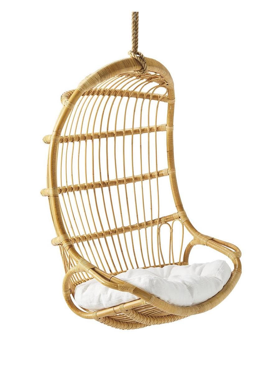 Serena and Lily hanging rattan chair with a white cushion in a sunlit room