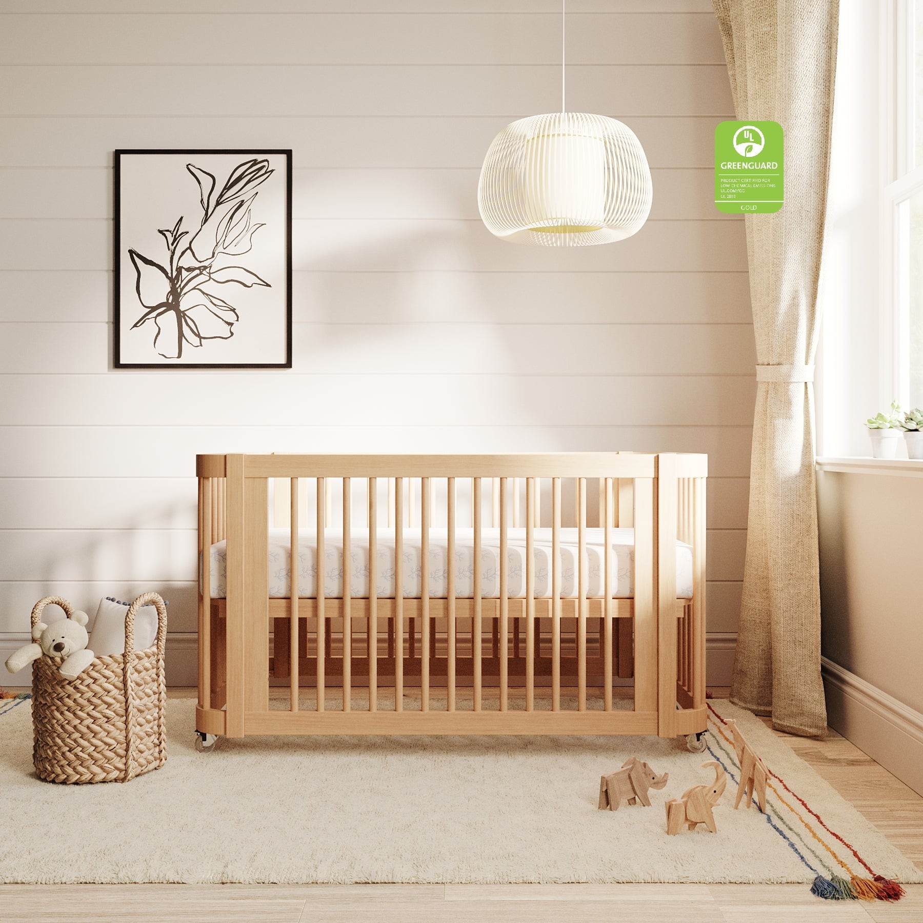 Nestig Wave crib in Natural Wood with rounded corners and open spindles in a nursery