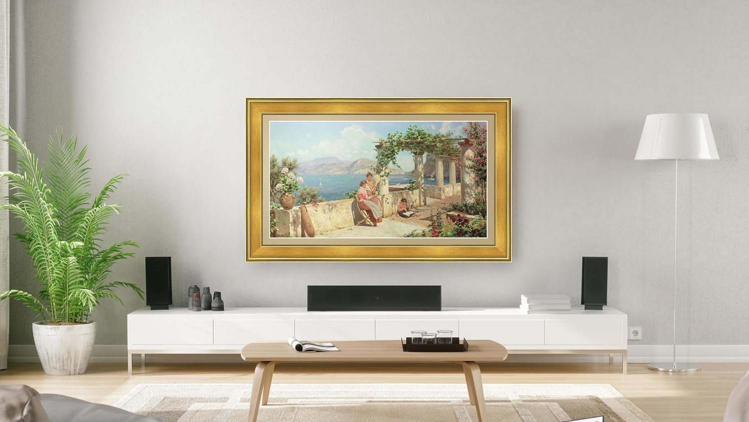 Art TV in an antique gold frame displaying a classical painting, hung above a low white media console